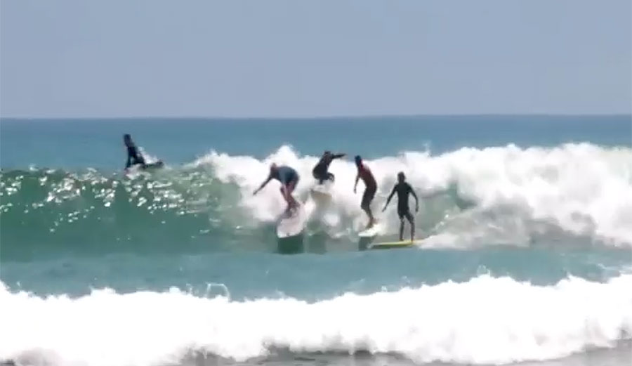 Joel Tudor cruises down the line at Malibu before not one but THREE people decide that now would be a good time to drop in. 