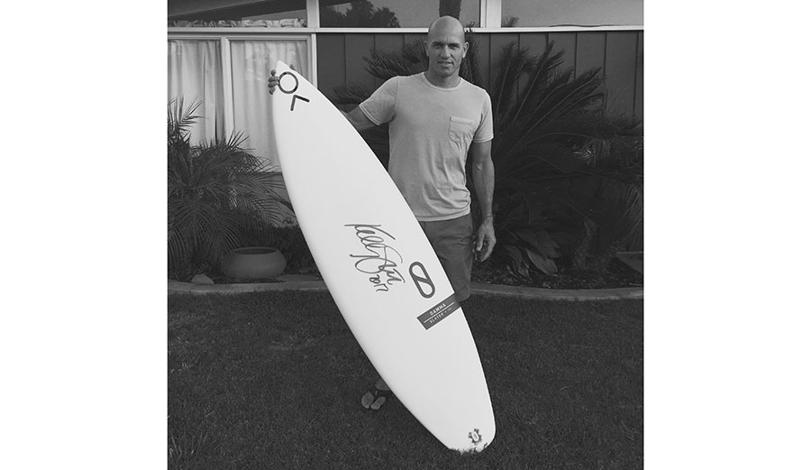 Kelly Slater touched a pen to surfboard and made it worth $25,000. Photo: SurfAid