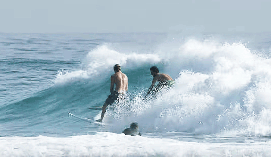 John John Florence party waves with a longboarder who looks suspiciously like Filipe Toledo.
