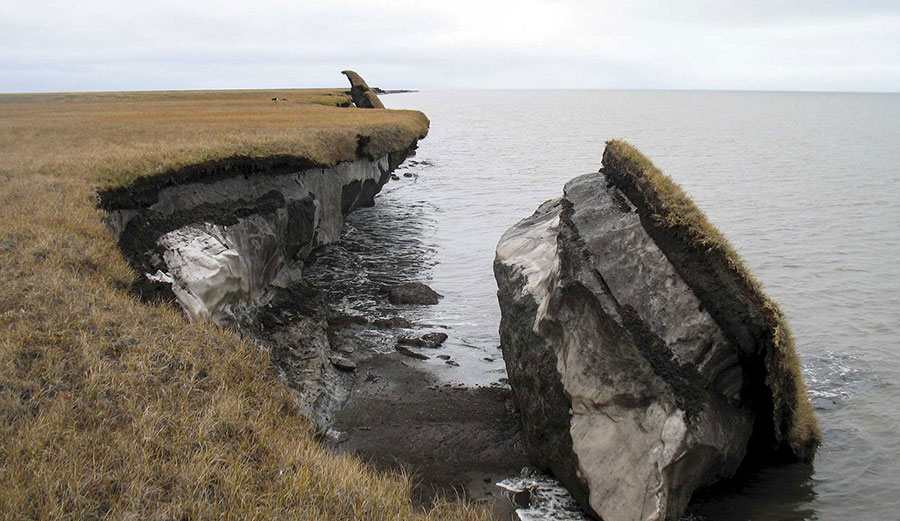 Collapsed block of ice-rich permafrost along Drew Point, Alaska, at the edge of the Beaufort Sea. Coastal bluffs in this region can erode 20 meters a year (around 65 feet).