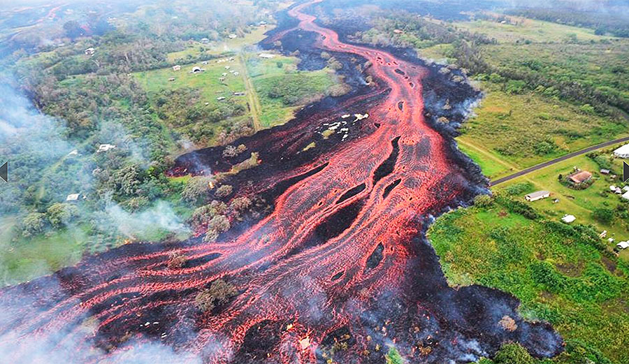 Saturday, May 19, 2018. A photo released by the U.S. Geological Survey shows lava flowing from fissures near Pahoa, Hawaii. Kilauea volcano began erupting more than two weeks ago and has burned dozens of homes, forced people to flee and shot up plumes of steam from its summit that led officials to distribute face masks to protect against ash particles. Image: U.S. Geological Survey via AP