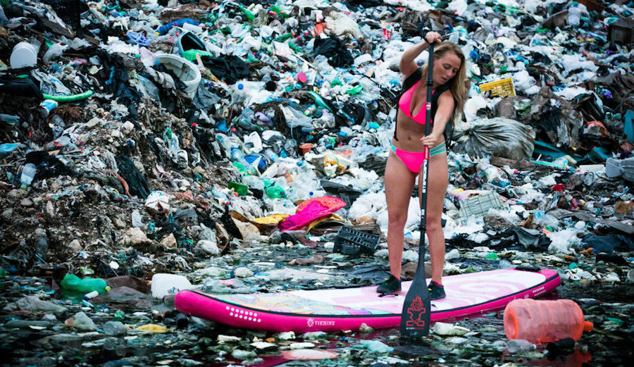 Alison Teal paddles through a sea of trash in Yucatan Mexico.