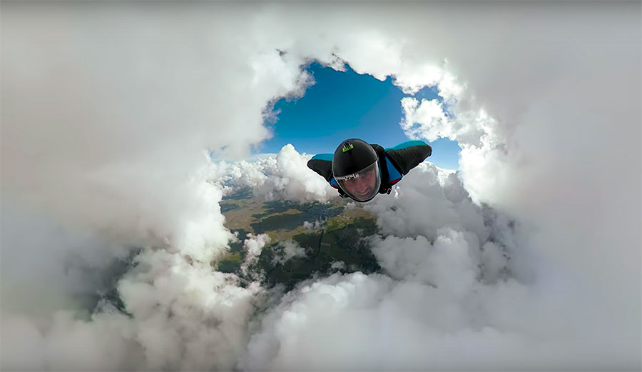 WIngsuit flying through a cloud cave.