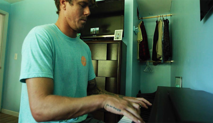 Albee Layer plays a Pixies cover as Nathan Fletcher, Filipe Toledo, and Julian Wilson surf across the screen.