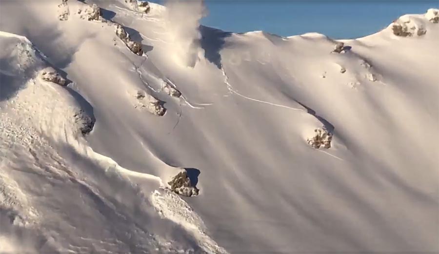helicopter bombs start massive avalanches in the alps