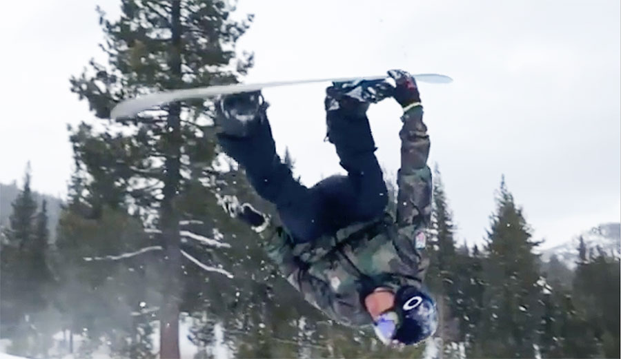 Kai Lenny backflips on a snowboard