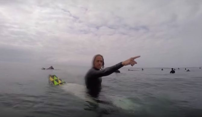Guy pointing surf lineup