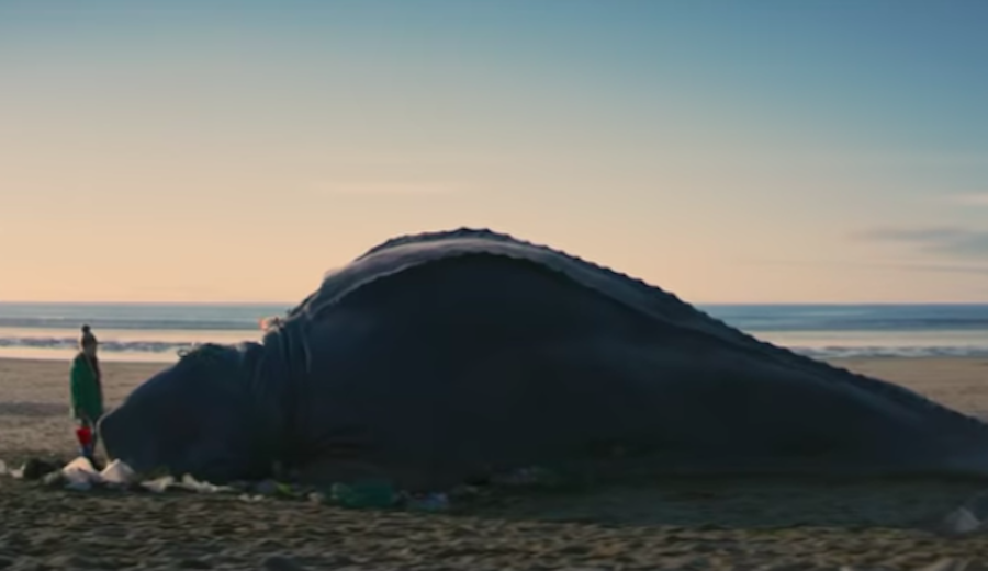 A girl stands next to a mysterious creature that's died from ingesting ocean plastic in this fictional short by Surfers Against Sewage. Photo: Screenshot/Youtube