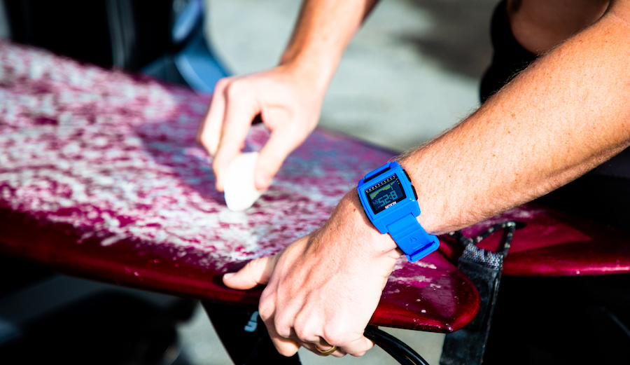 The Nixon Base Tide Pro applying surf wax