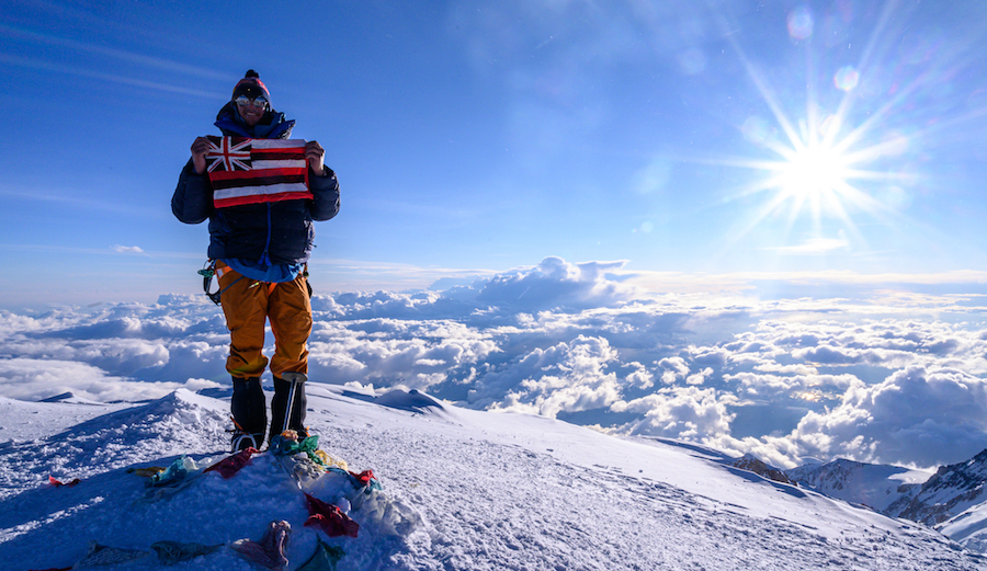 Ian Walsh with his home made Hawaiian flag on the summit of Denali