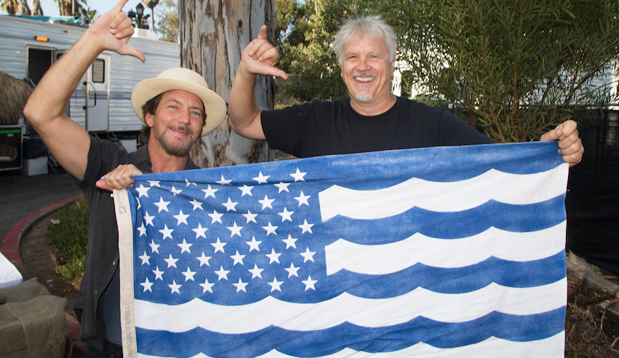 Eddie Vedder and Tim Robbins pose with Surfrider's USOA Flag