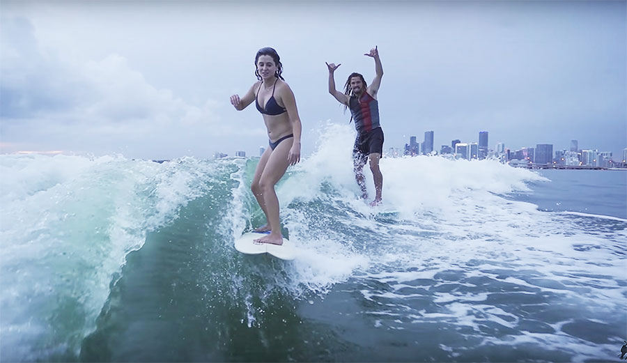 Austin Keen and Anastasia Ashley wakesurfing