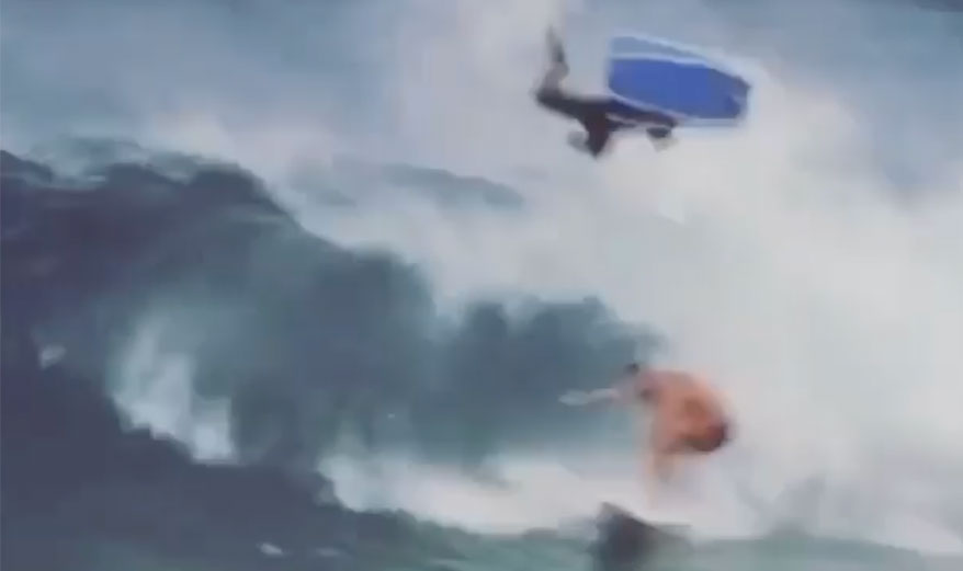 Bodyboarder airs over surfer in barrel