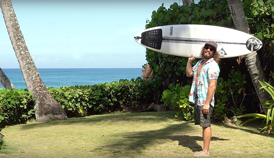 Timmy Reyes with surfboard in Hawaii