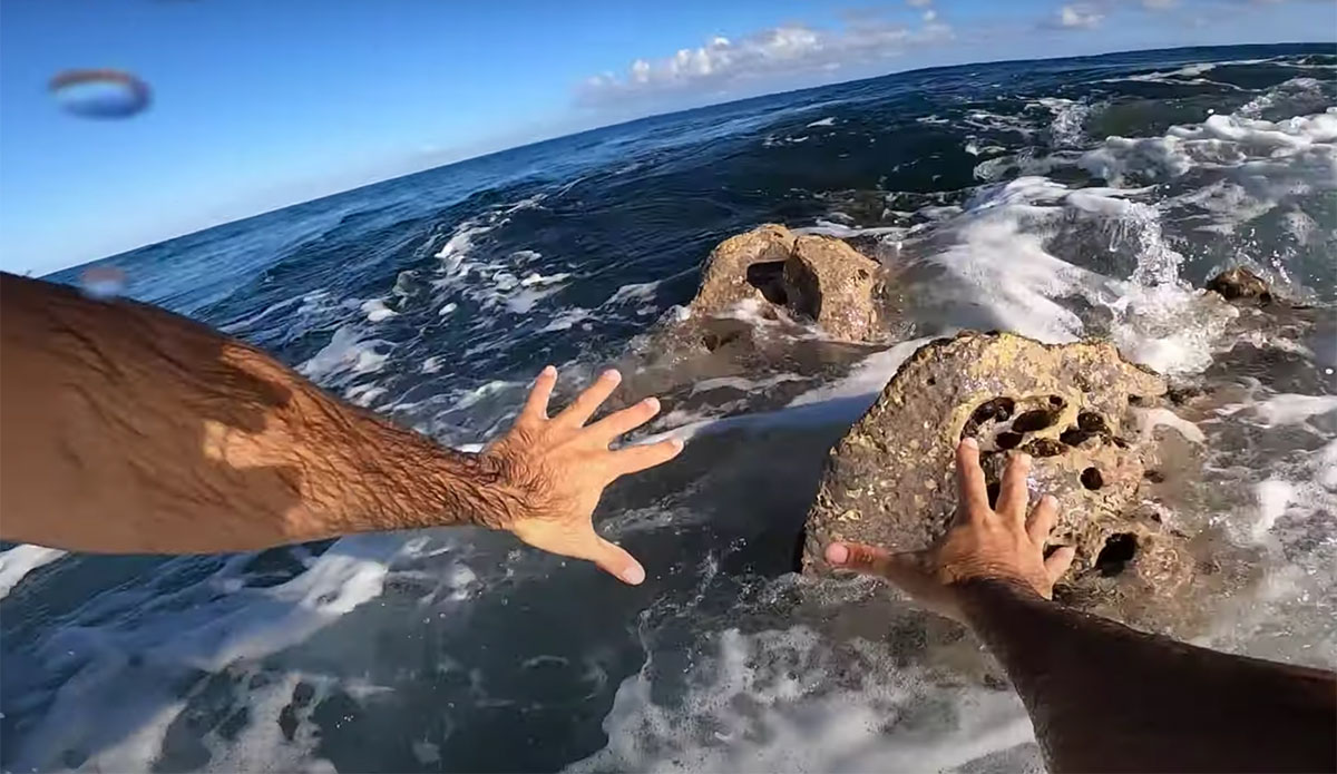 Mason Ho surfing over rocks