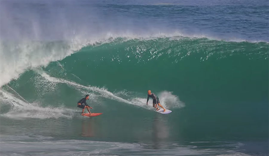 Kelly Slater and Rizal Tandjung surfing at Padang Padang