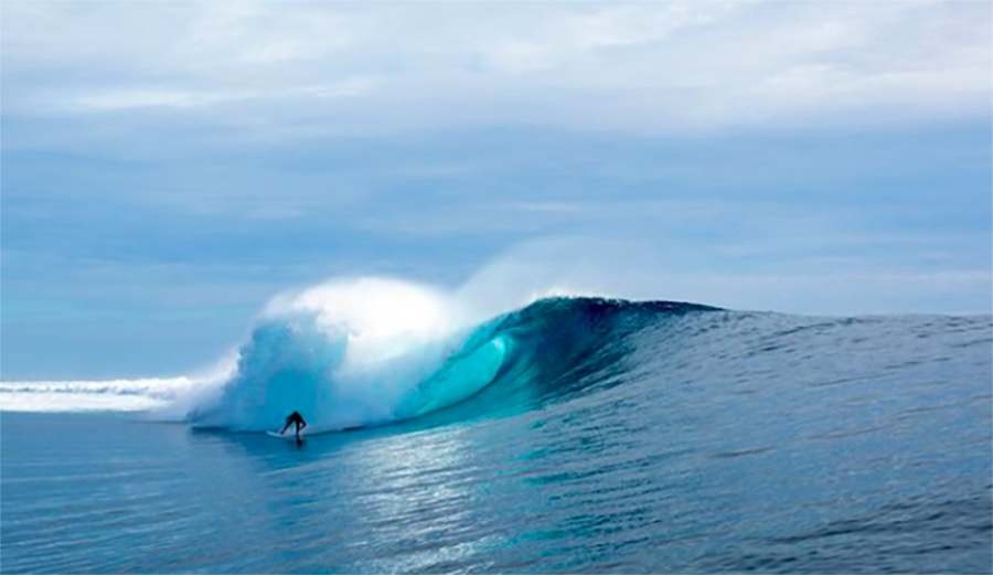 A surfer rides Cloudbreak near Fiji