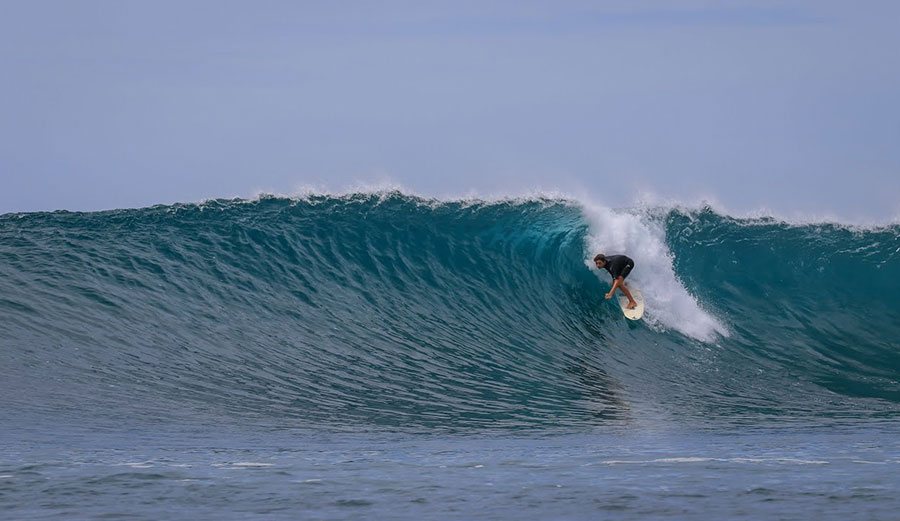 Luke Tema surfing a wave in the Mentawai Islands