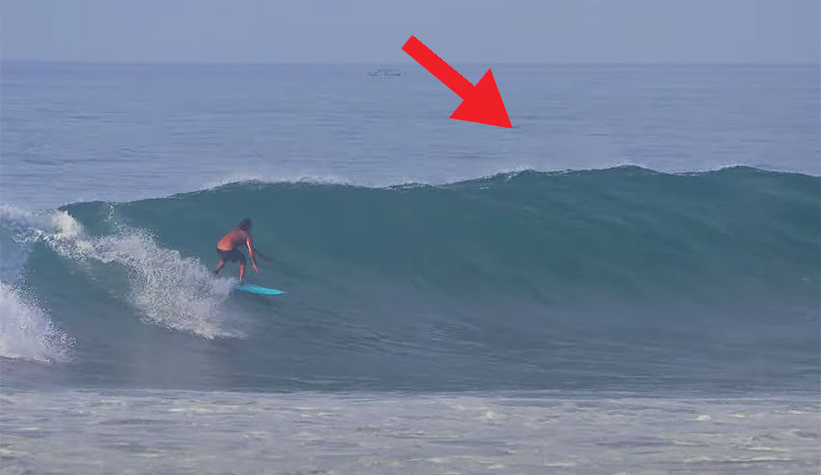 Surfer about to get barreled on a wave in Indonesia