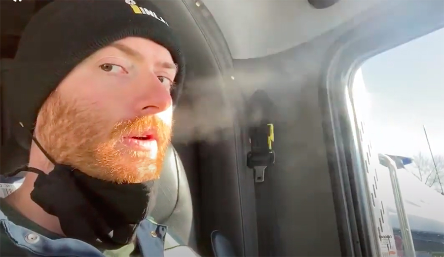 Man demonstrates mask effectiveness with his cold breath