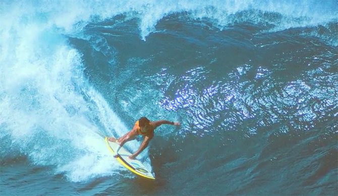 Michael Ho riding the barrel at Pipeline with a cast on his arm