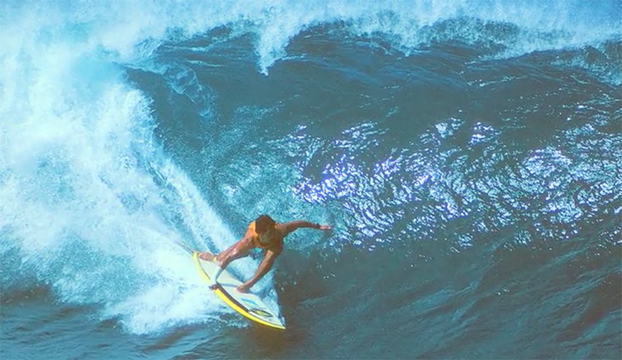 Michael Ho riding the barrel at Pipeline with a cast on his arm