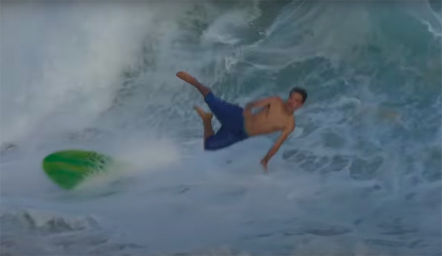 Skimboarder wrecks on a wave