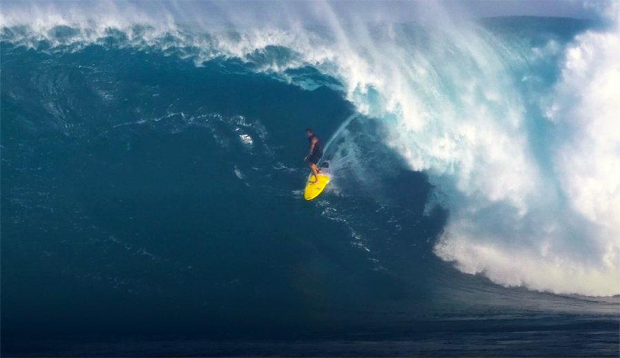 Albee Layer surfing in the barrel at Jaws