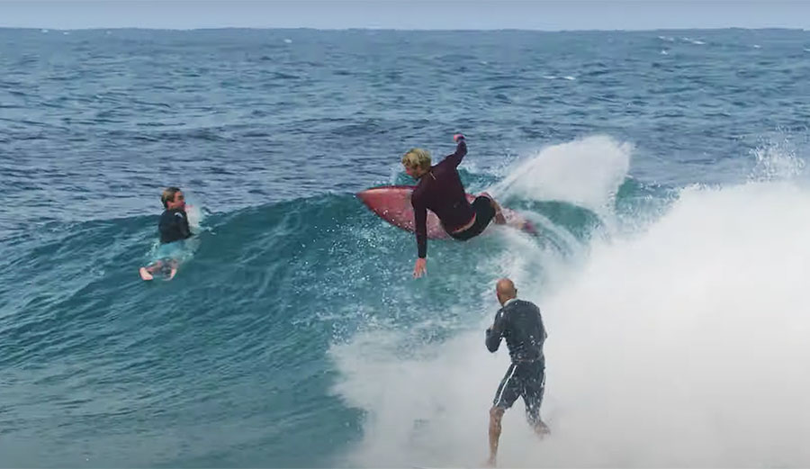 Kelly Slater and John John Florence surfing a wave together