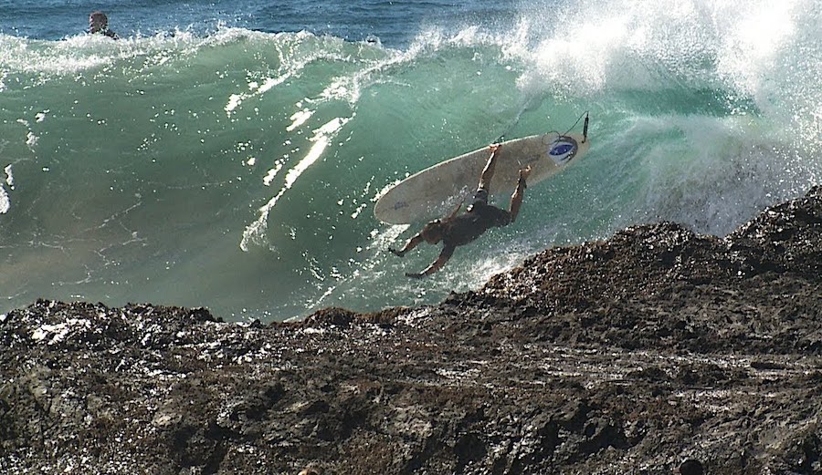a surfer crashes at Snapper Rocks on the Gold Coast, Australia
