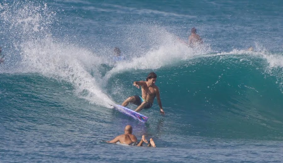 Mason Ho cuts back on a wave with Kelly Slater on the shoulder