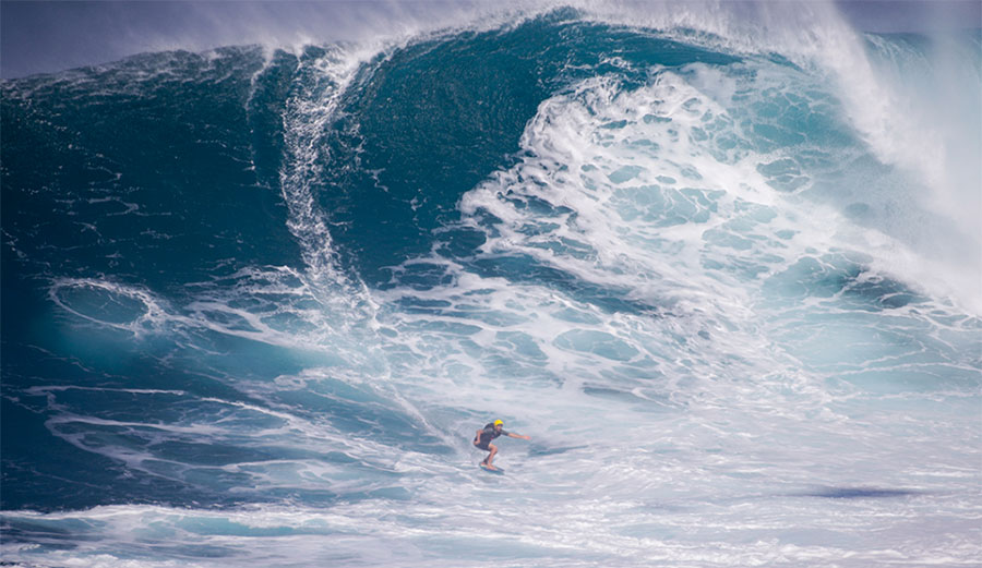 Sean McClenahan riding massive Jaws on a skimboard.