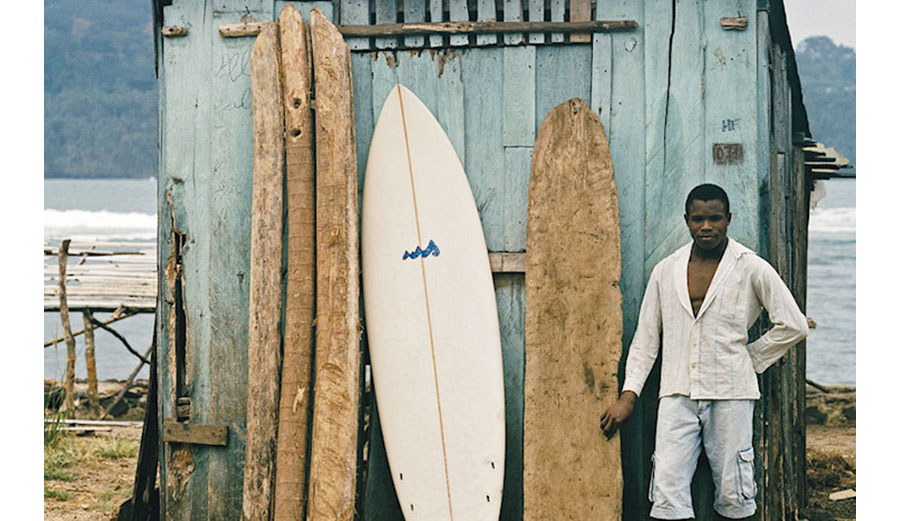 man in front of african surf boards