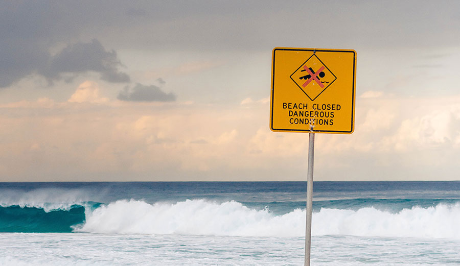 Beach closed sign on beach