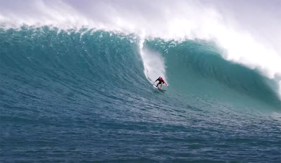 Ben Gravy tow surfing big wave on the North Shore