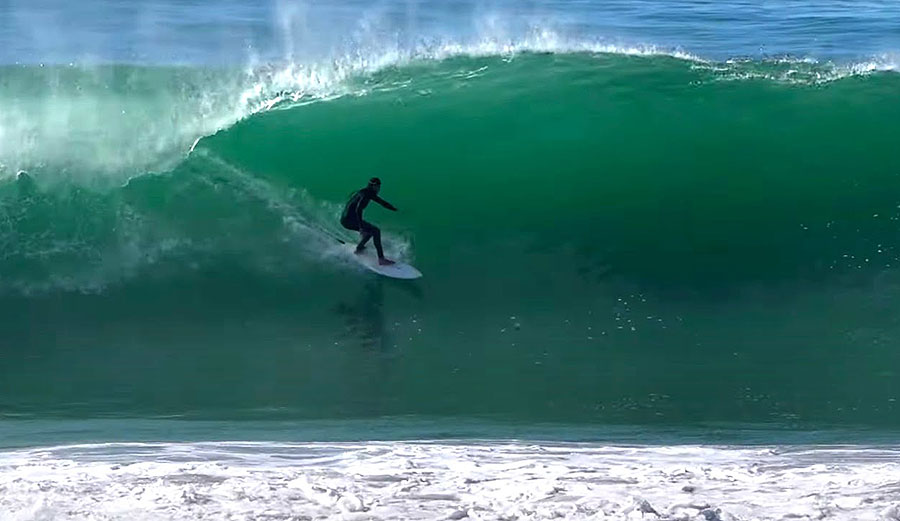 Surfer on a left barrel at Black's Beach