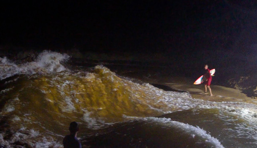 Jamie O'Brien looks at the Waimea Bay River wave