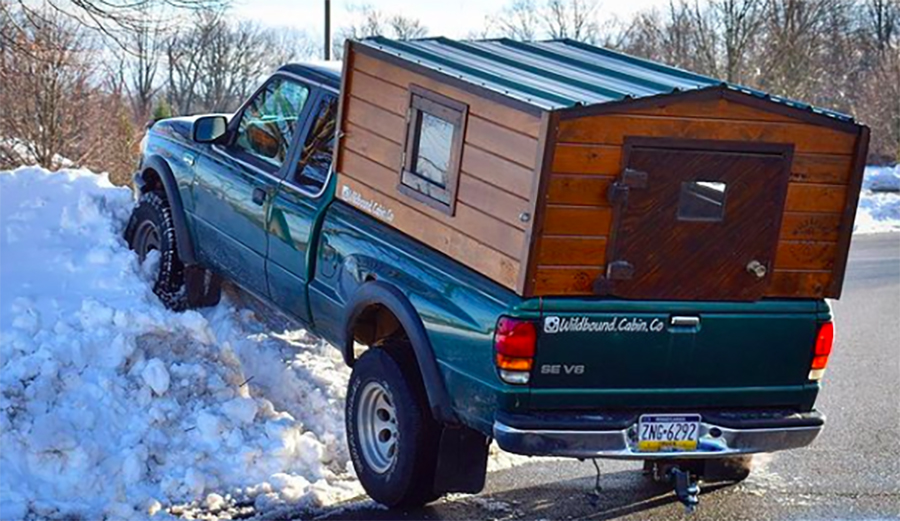 a tiny house cabin camper on a truck