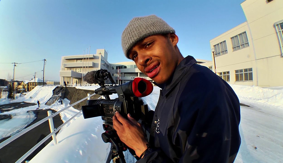 Snowboarder Dillon Ojo looks through the camera
