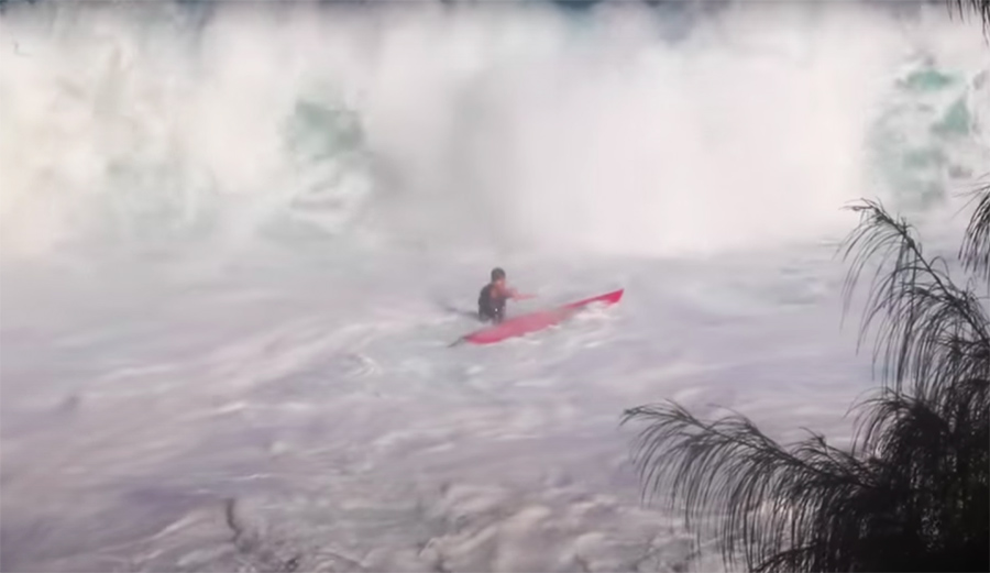 a surfer gets crushed on the paddle out at jaws