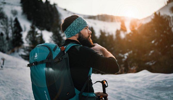skier on mountain with backpack from unsplash