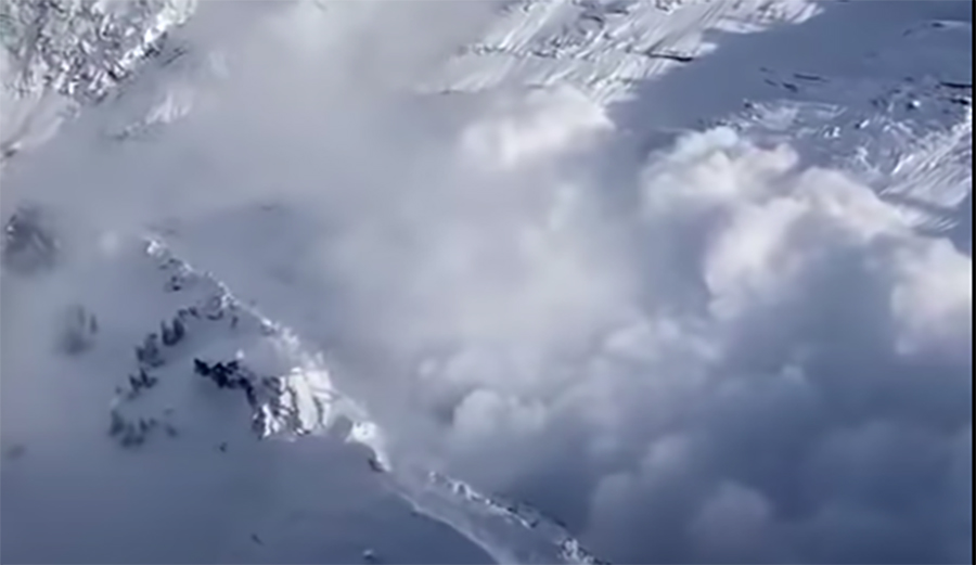 a giant avalanche careens down a canyon in Utah