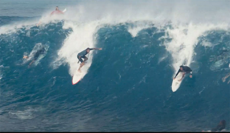 Two surfers on wave at Pipeline