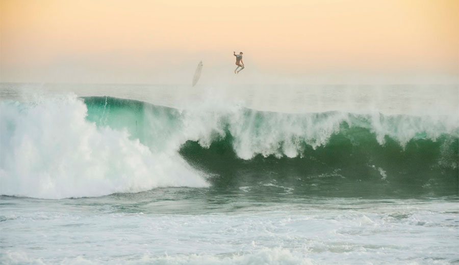 Man falling off back of wave