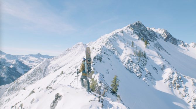 Aerial view of the top of a snow-capped mountain on a bright day.