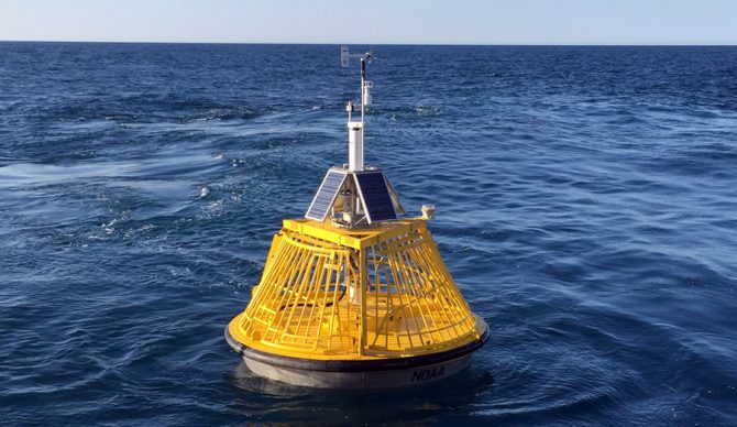 A buoy that gives wave height and wind informations sits in the ocean