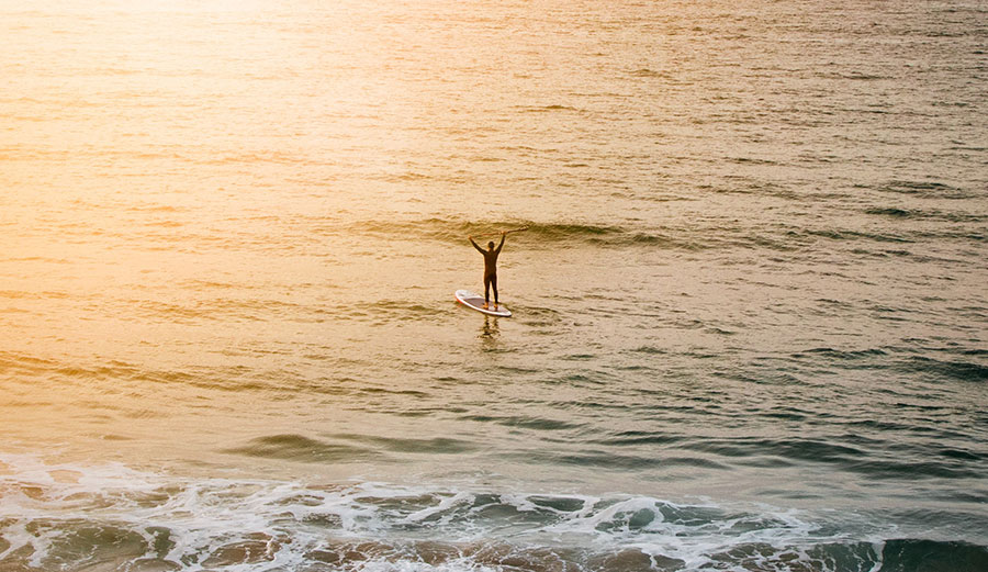 Paddler celebrating on ocean