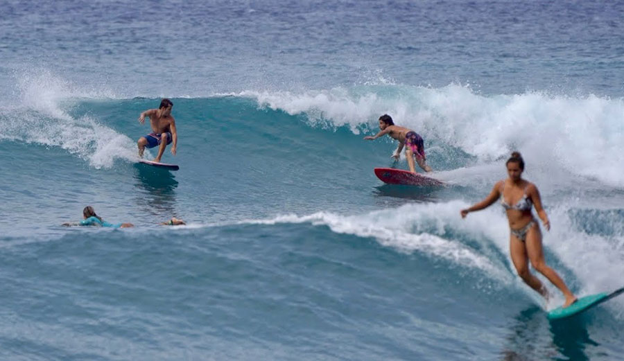 Mason Ho and Sheldon Paishon surfing the same wave at Makaha