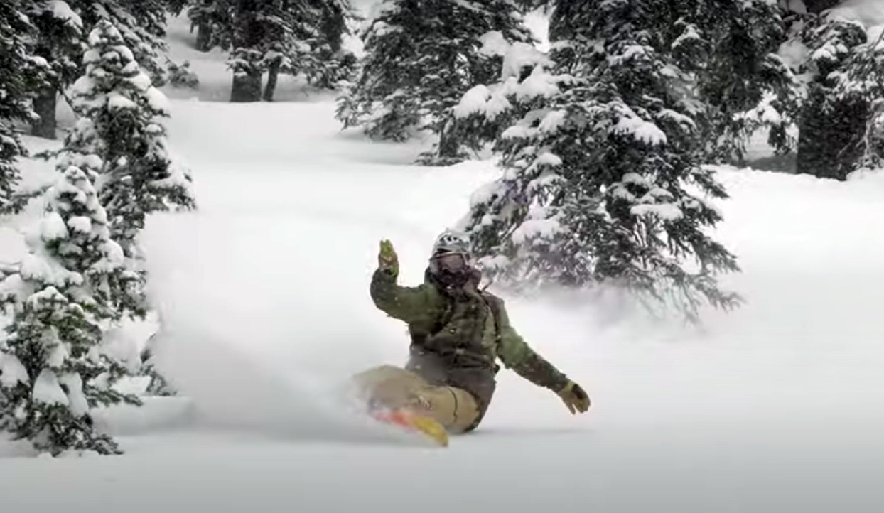 Bryan Fox with a beautiful turn in powder on a snowboard
