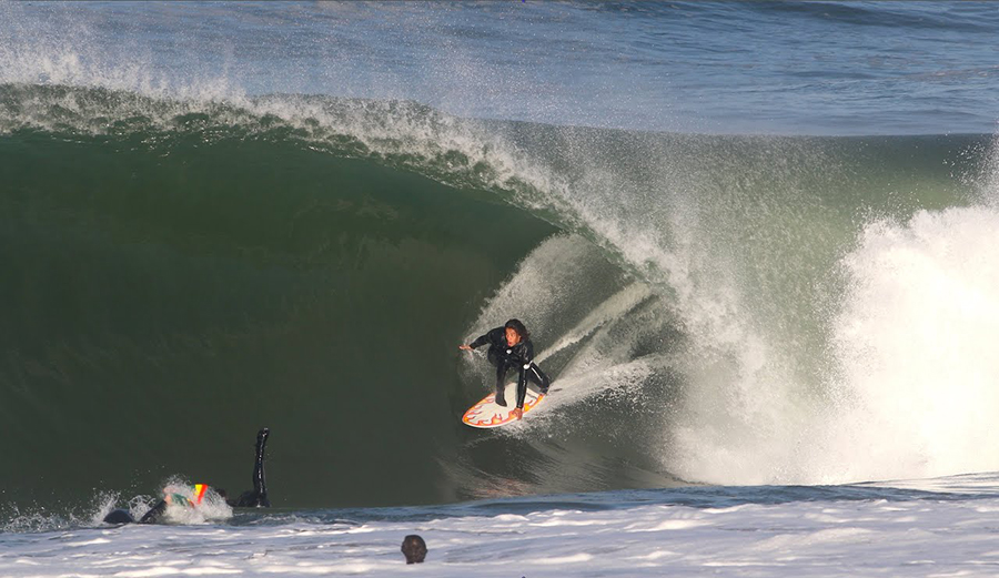 A surfer in a barrel at El Porto